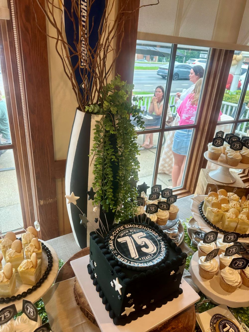 the front of the Bar-B-Cutie building decorated with colorful balloons